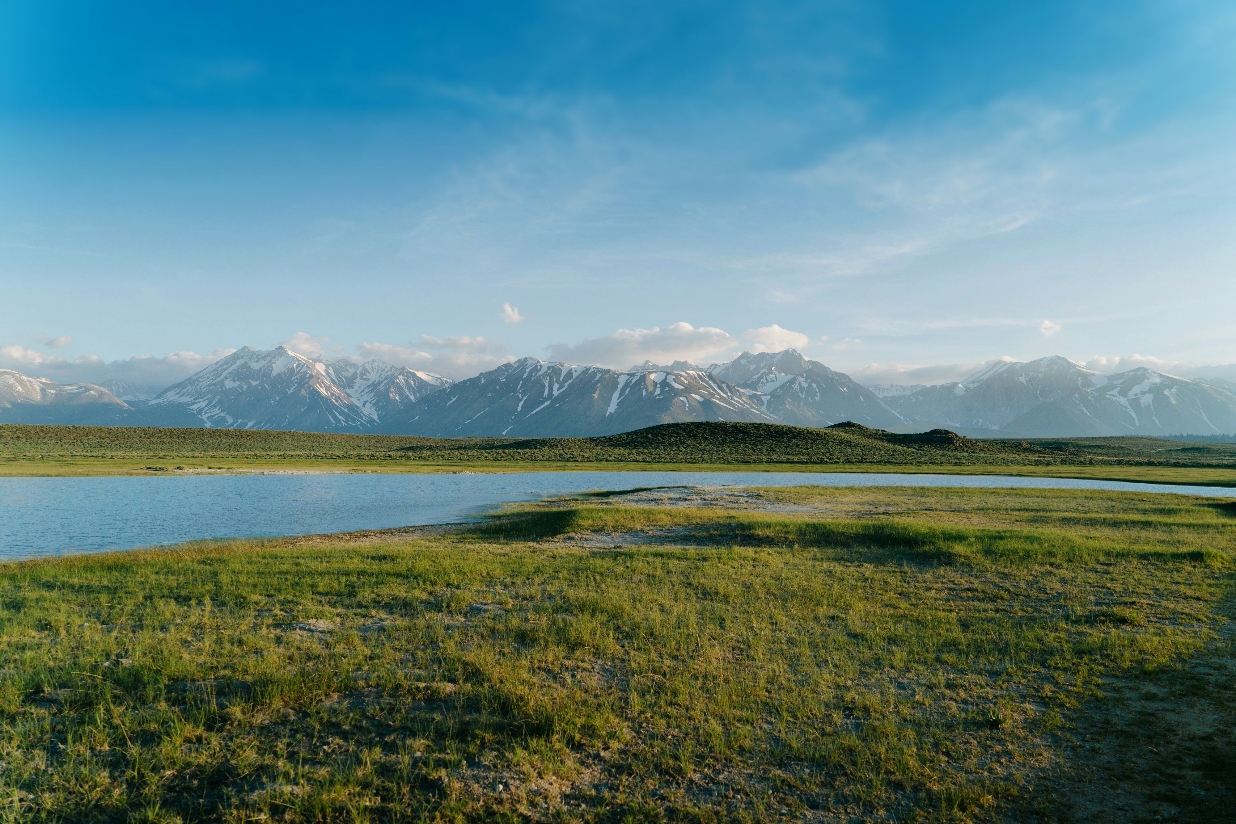 A Large Body of Water Surrounded By Mountains